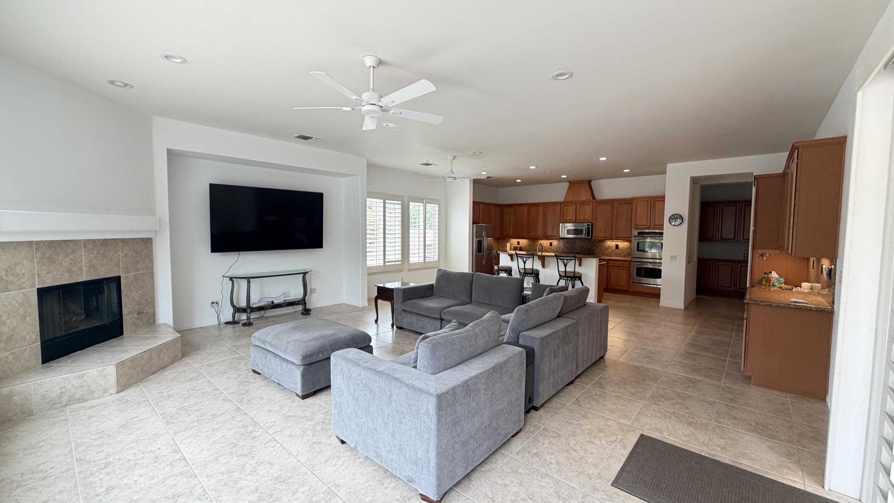 49578 Colorado Street Indio, CA 92201 - Photo 7 of 37 a living room with furniture and a fireplace