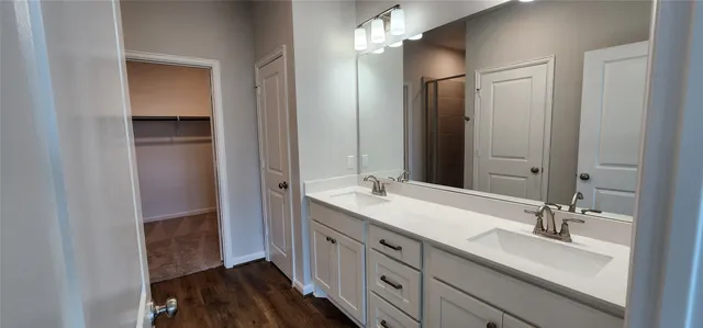 a bathroom with a double vanity sink and mirror