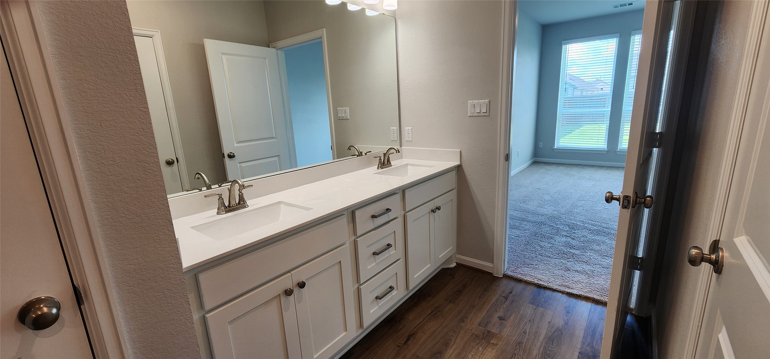 148 Los Olives Lane Georgetown, TX 78628 - Photo 20 of 38 Full bath featuring double vanity and dark wood-style floors