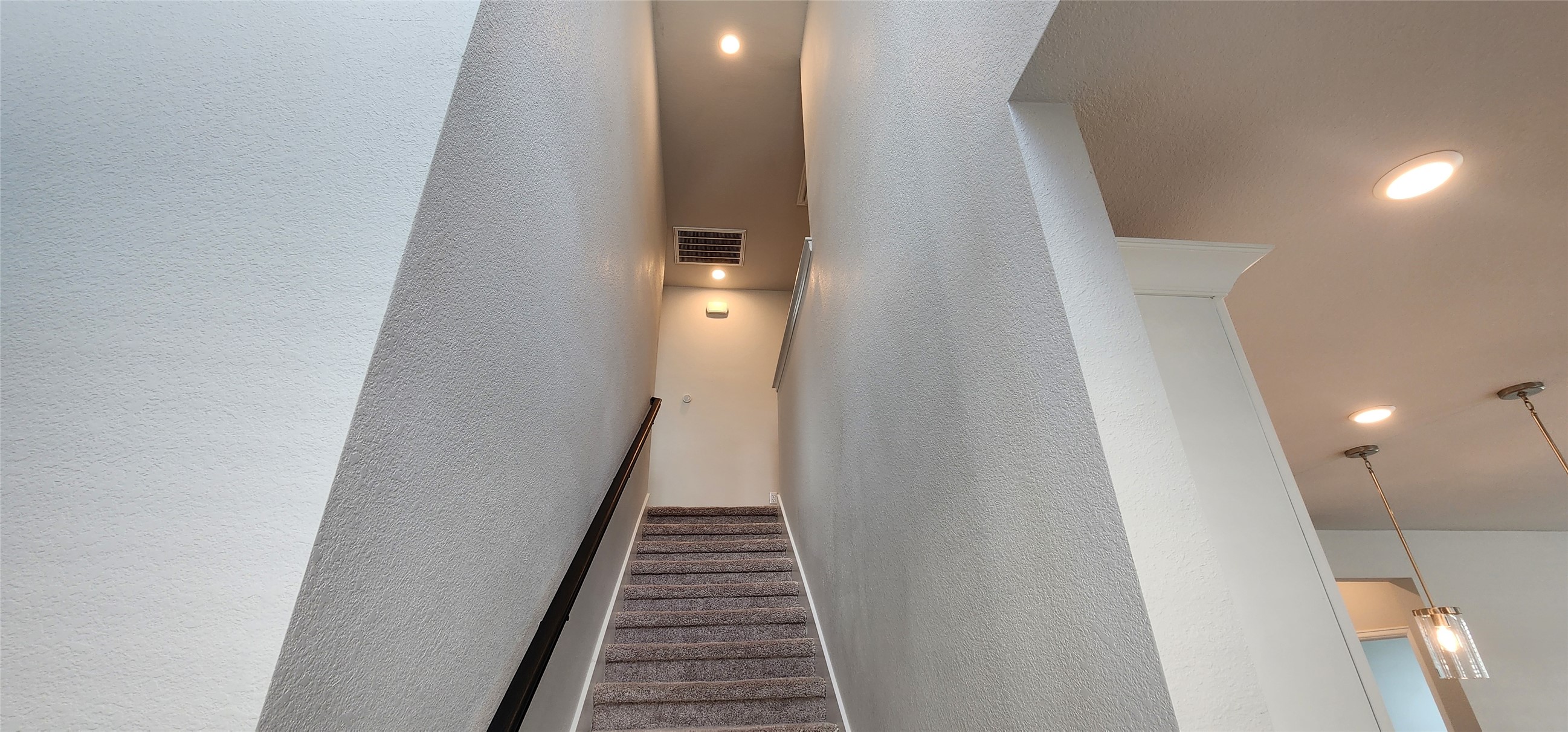 148 Los Olives Lane Georgetown, TX 78628 - Photo 25 of 38 Stairway with recessed lighting and a textured wall