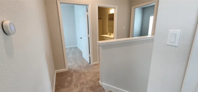 a view of a bathroom from a corridor