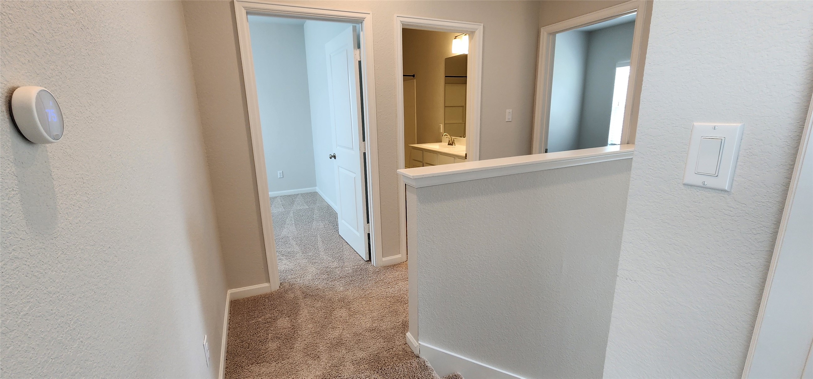 148 Los Olives Lane Georgetown, TX 78628 - Photo 26 of 38 Corridor with light carpet and a textured wall
