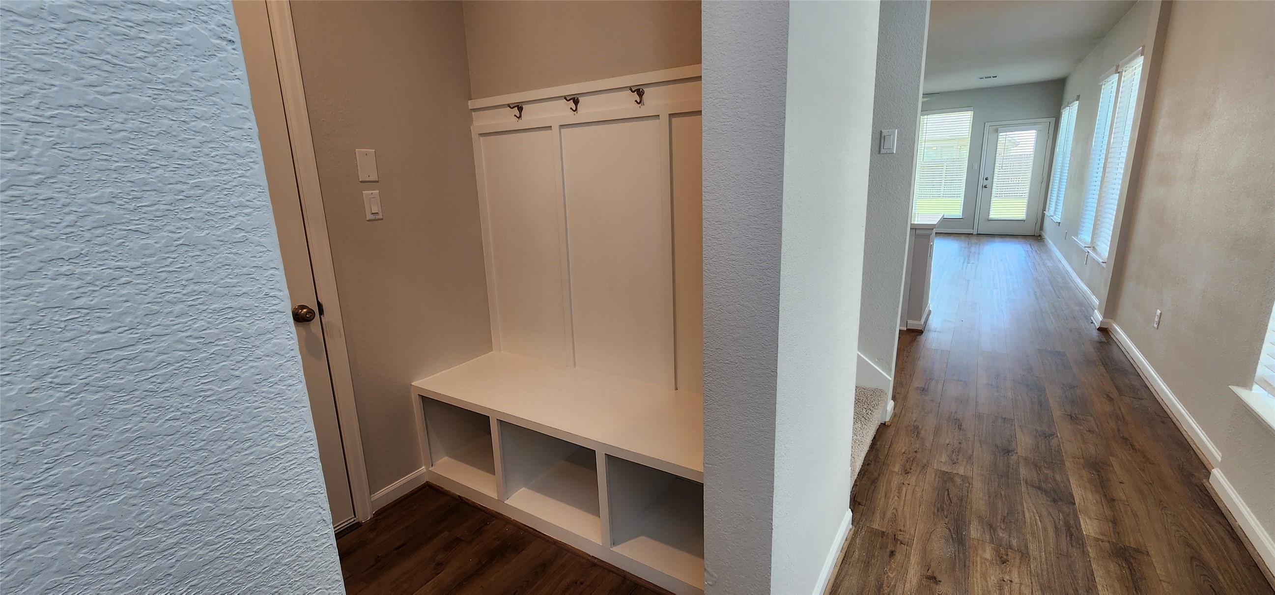 148 Los Olives Lane Georgetown, TX 78628 - Photo 3 of 38 Mudroom with a textured wall and dark wood-style floors