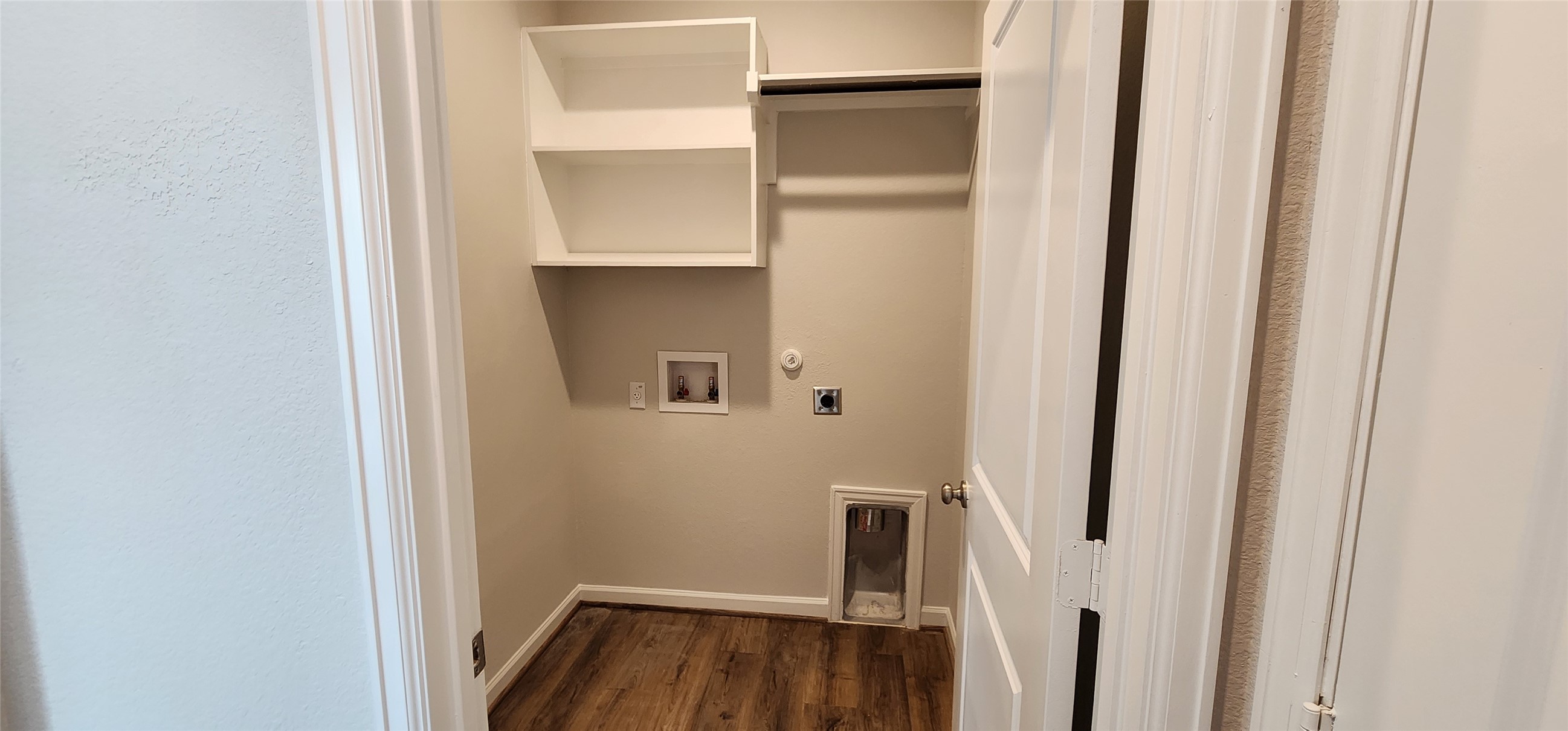 148 Los Olives Lane Georgetown, TX 78628 - Photo 4 of 38 Laundry room with gas dryer hookup, dark wood finished floors, hookup for a washing machine, and hookup for an electric dryer
