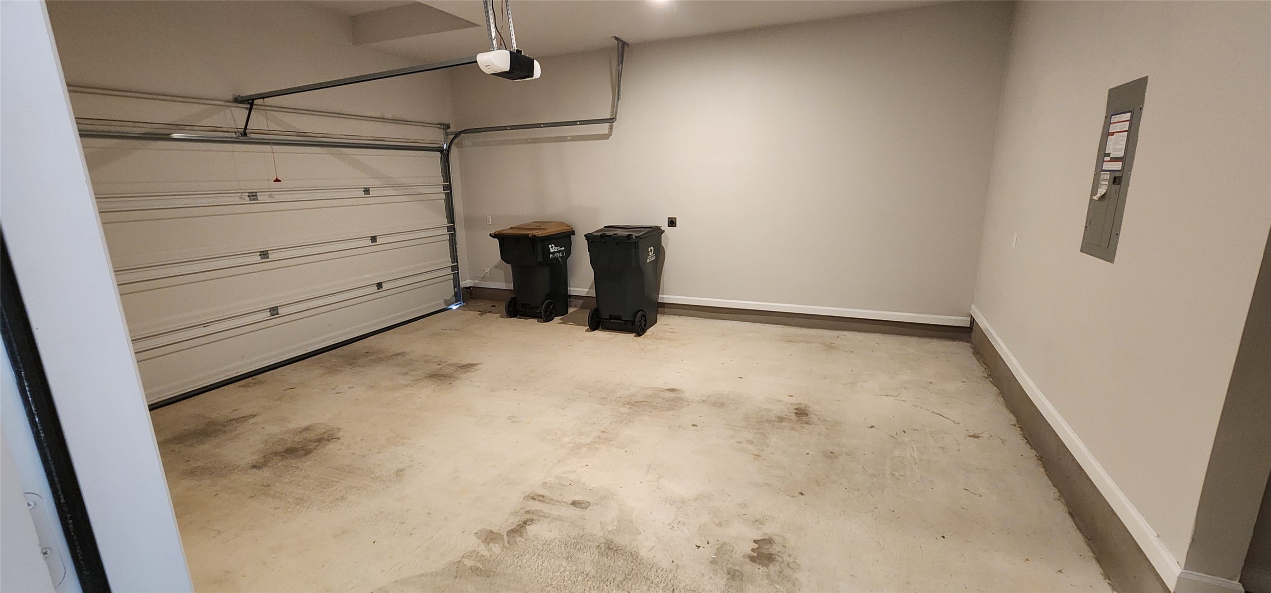 148 Los Olives Lane Georgetown, TX 78628 - Photo 5 of 38 Garage with electric panel and a garage door opener