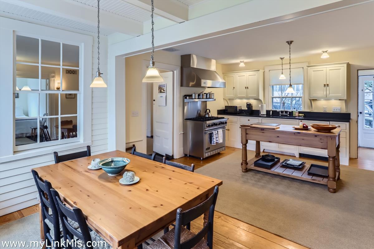 27 Spring Street Vineyard Haven, MA 02568 - Photo 10 of 58 a kitchen with a table chairs stove and refrigerator