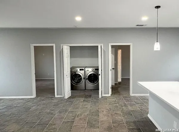a view of a hallway with a washer and dryer