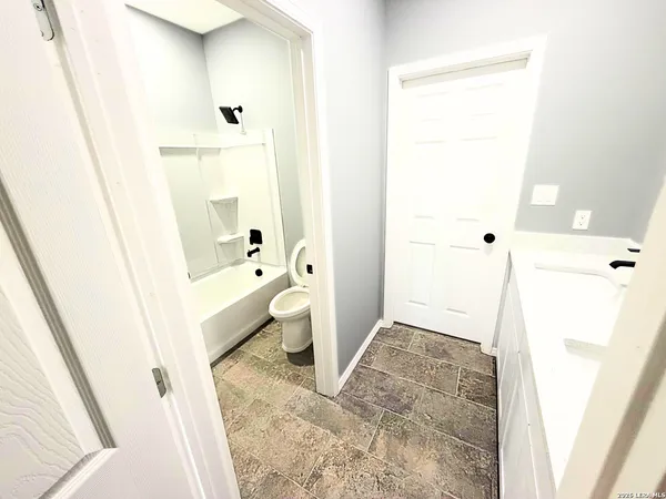 a bathroom with a bathtub sink and toilet