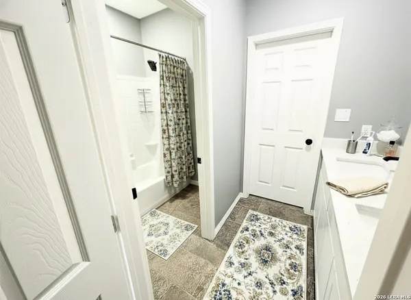 a bathroom with a shower and a sink