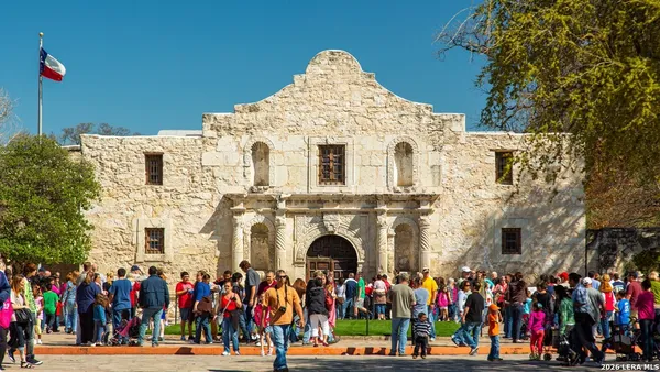 a front view of a building with lots of people