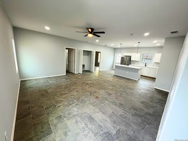 a view of a kitchen with a sink and a refrigerator