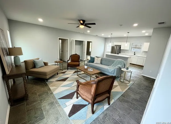 a living room with furniture and a wooden floor