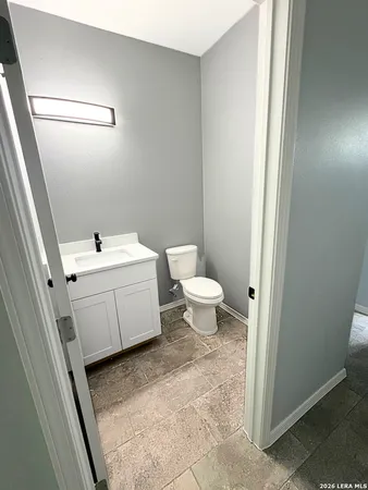 a bathroom with a toilet sink and mirror