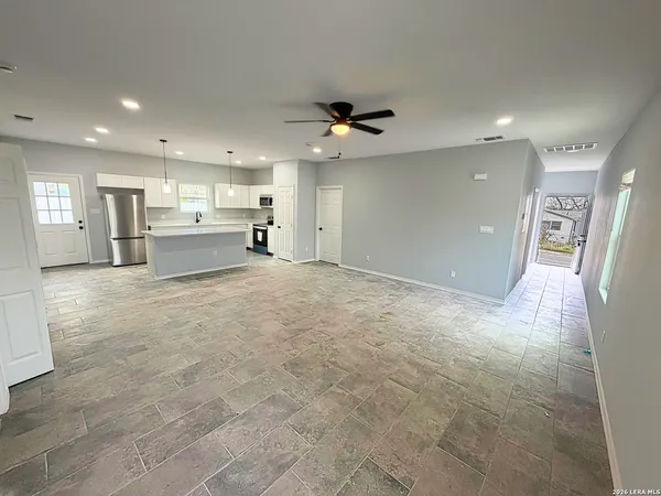 a view of a kitchen with a sink and a refrigerator