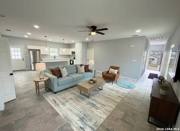 a living room with furniture and a chandelier