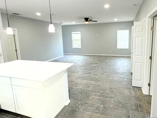 a view of a livingroom with a dishwasher and cabinets