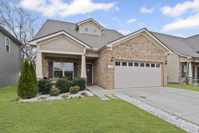 a front view of a house with a garden and plants