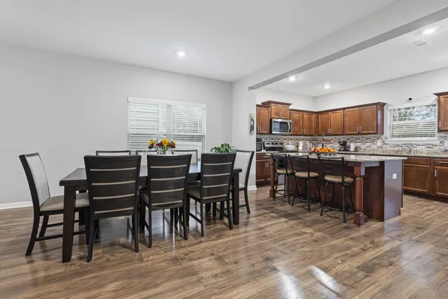 a view of a dining room with furniture and wooden floor