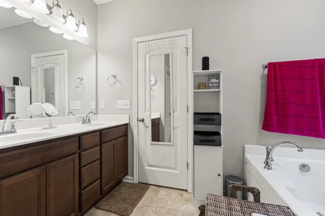 a bathroom with a double vanity sink a mirror and shower