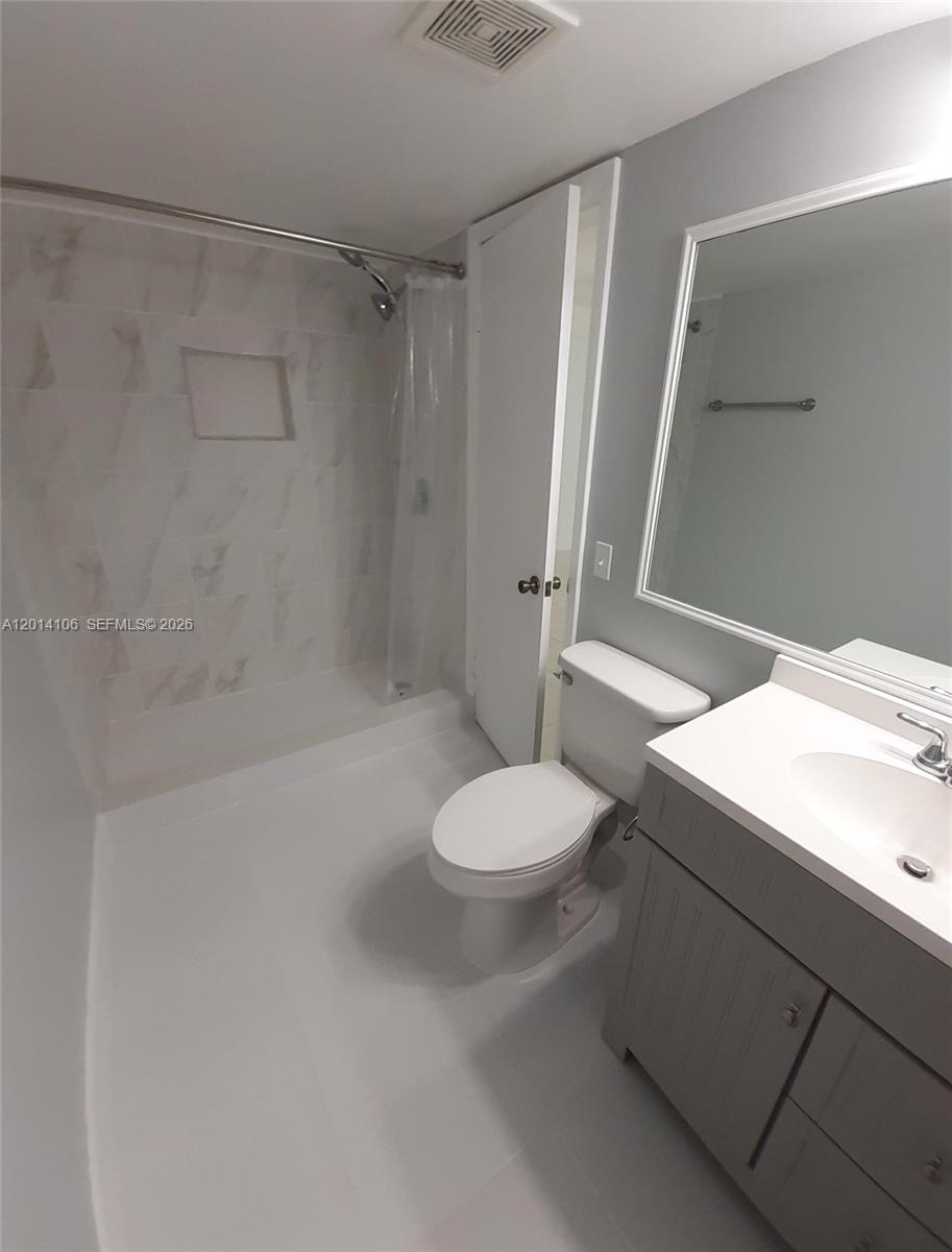 11800 Southwest 18th Street, Unit 3144 Miami, FL 33175 - Photo 12 of 23 a bathroom with a sink a toilet and shower