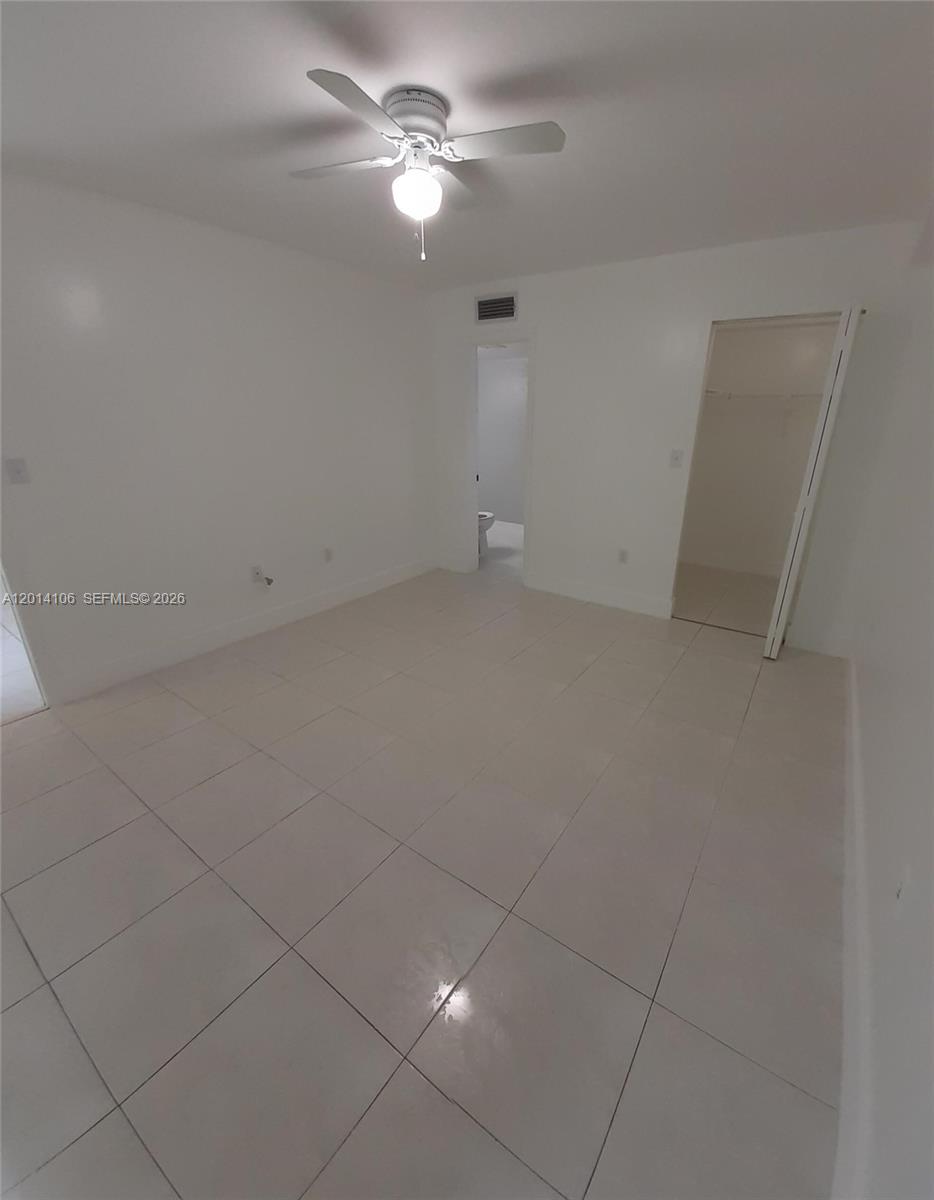11800 Southwest 18th Street, Unit 3144 Miami, FL 33175 - Photo 15 of 23 en empty room with ceiling fan and window
