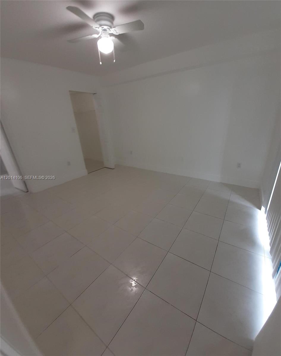 11800 Southwest 18th Street, Unit 3144 Miami, FL 33175 - Photo 16 of 23 en empty room with ceiling fan and window