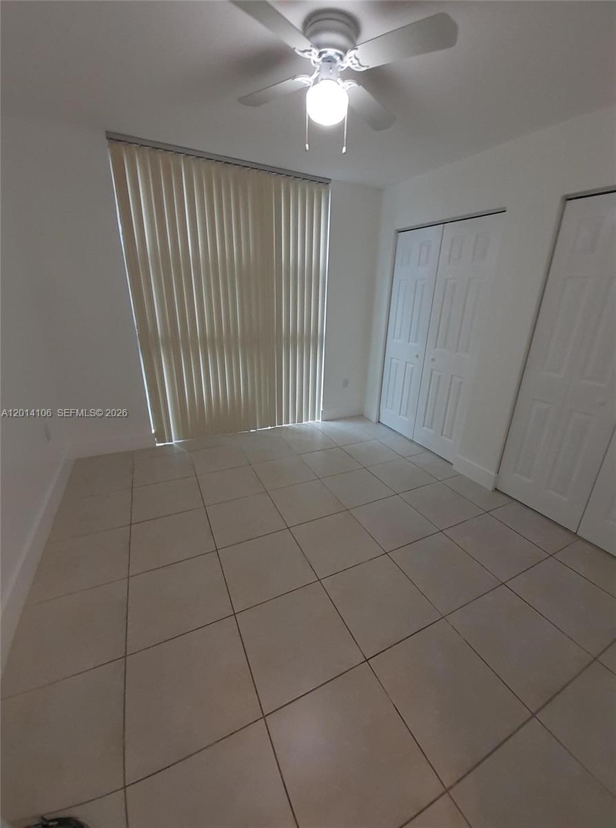 11800 Southwest 18th Street, Unit 3144 Miami, FL 33175 - Photo 18 of 23 a view of an empty room with a chandelier fan
