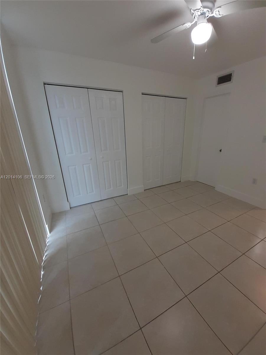 11800 Southwest 18th Street, Unit 3144 Miami, FL 33175 - Photo 19 of 23 a view of a livingroom with a ceiling fan and window