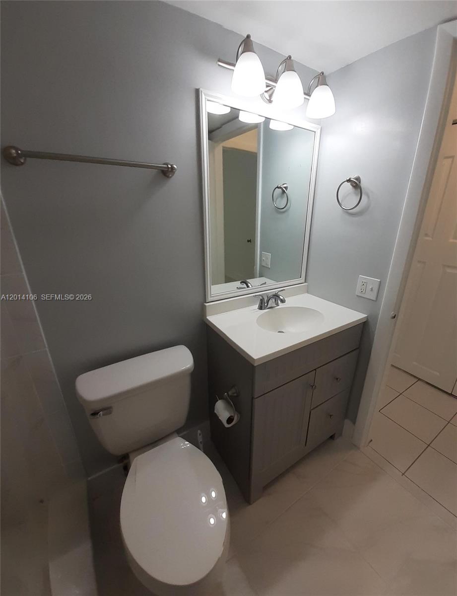 11800 Southwest 18th Street, Unit 3144 Miami, FL 33175 - Photo 20 of 23 a bathroom with a toilet sink and mirror