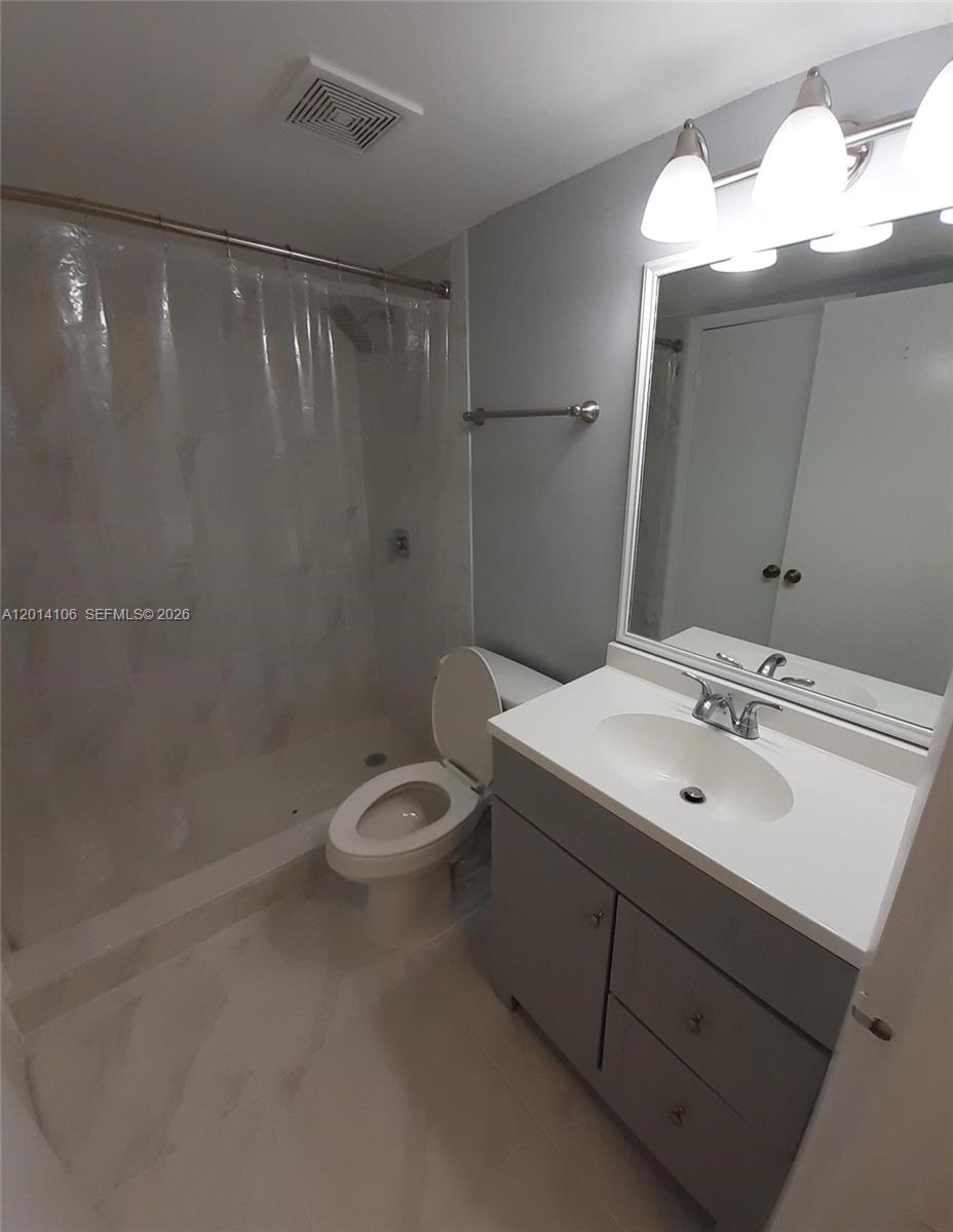 11800 Southwest 18th Street, Unit 3144 Miami, FL 33175 - Photo 21 of 23 a bathroom with a sink a toilet and shower