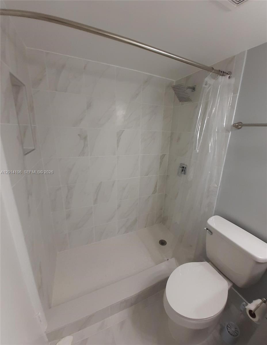 11800 Southwest 18th Street, Unit 3144 Miami, FL 33175 - Photo 22 of 23 a white toilet sitting next to a bath tub
