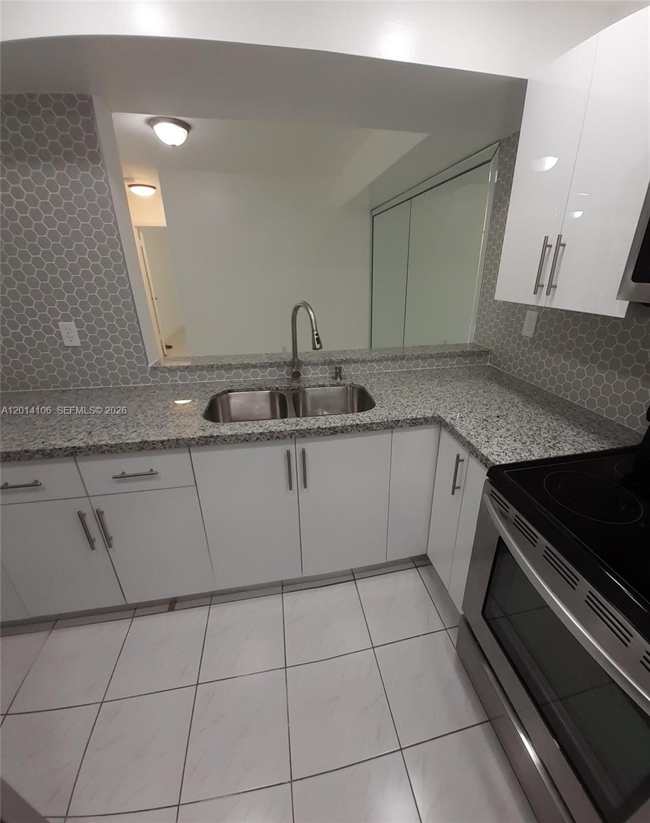 11800 Southwest 18th Street, Unit 3144 Miami, FL 33175 - Photo 5 of 23 a kitchen with a sink and cabinets