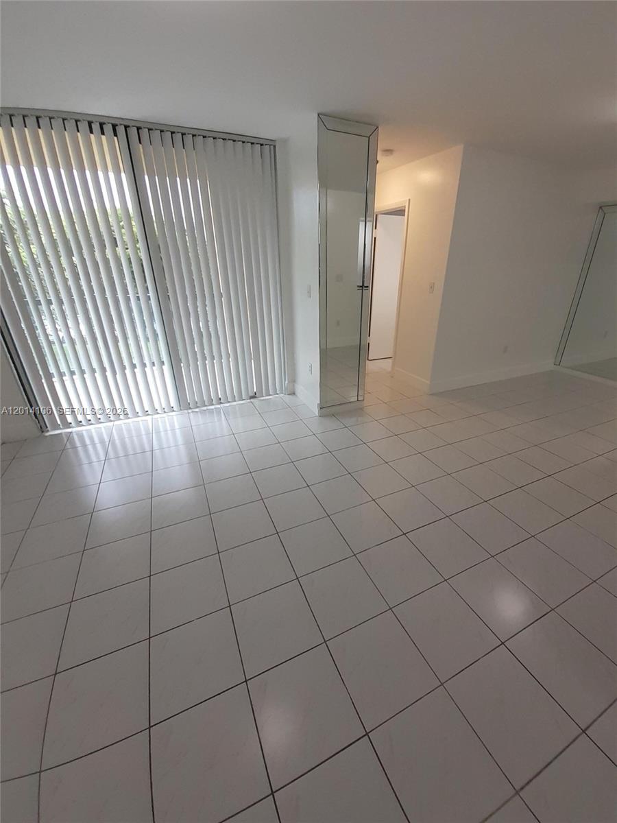 11800 Southwest 18th Street, Unit 3144 Miami, FL 33175 - Photo 9 of 23 an empty room with a mirror