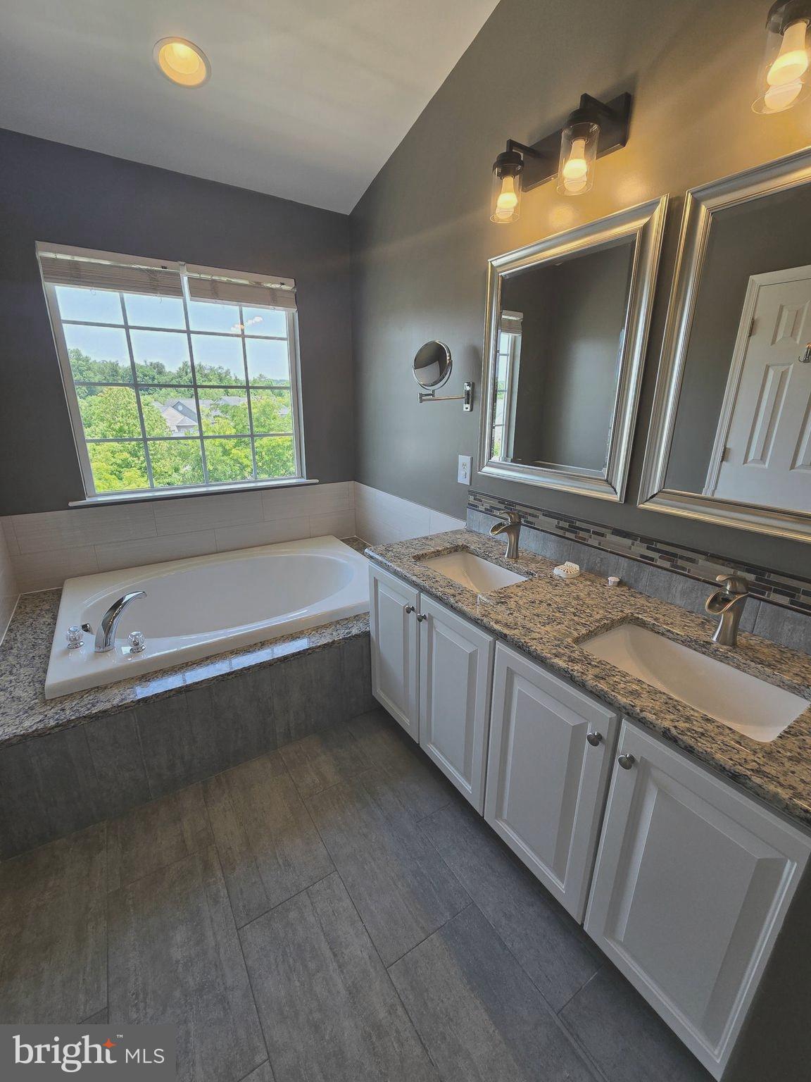11847 Skylark Road Clarksburg, MD 20871 - Photo 31 of 46 a bathroom with a granite countertop sink and a bathtub