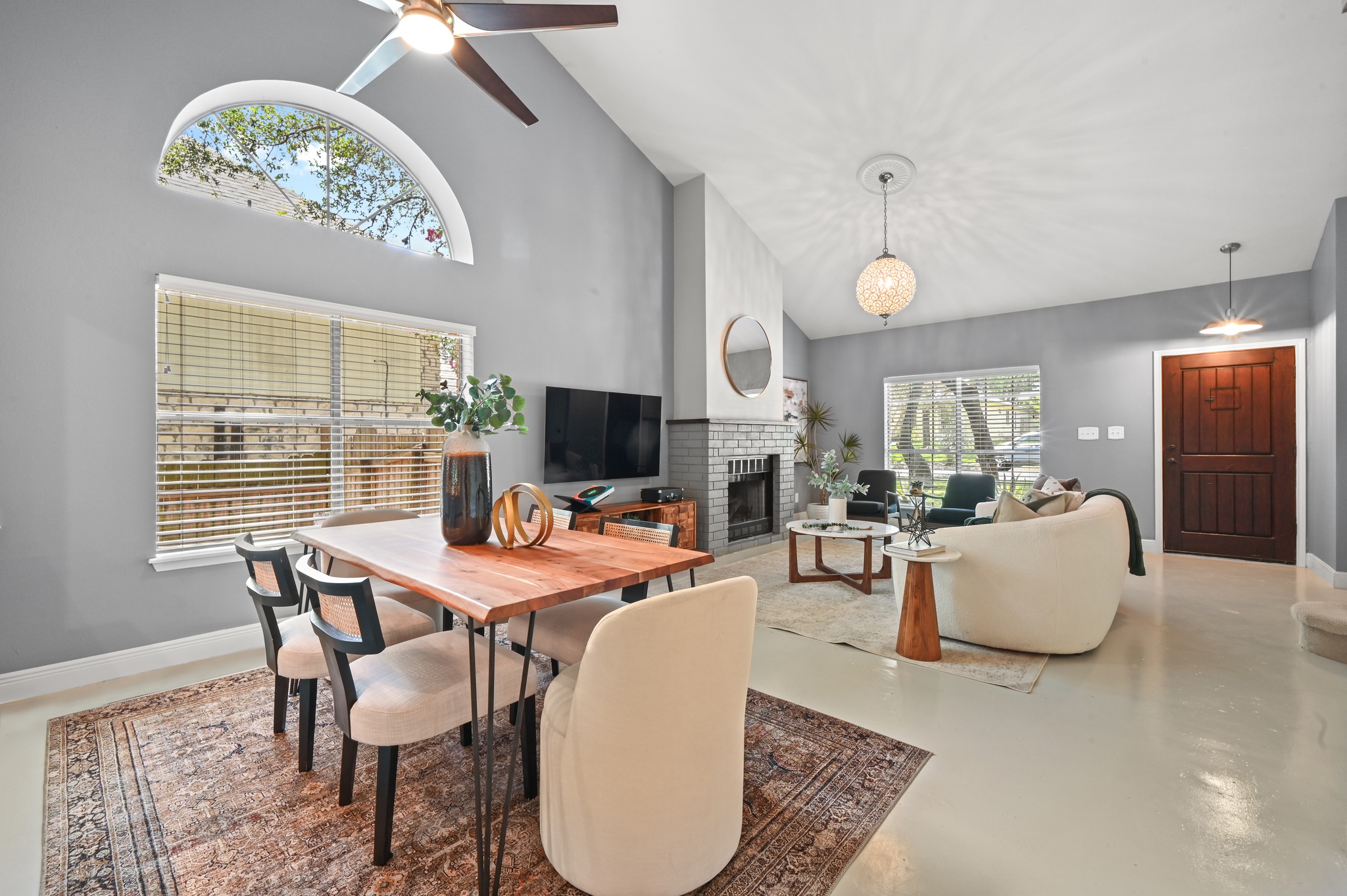 708 Shade Tree Drive Austin, TX 78748 - Photo 10 of 32 Step inside to find a luminous open concept living and dining area under soaring vaulted ceilings with refreshing polished concrete floors.