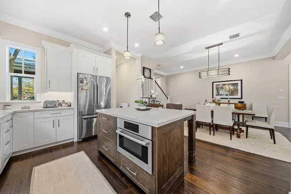 a kitchen with a stove a refrigerator and a table