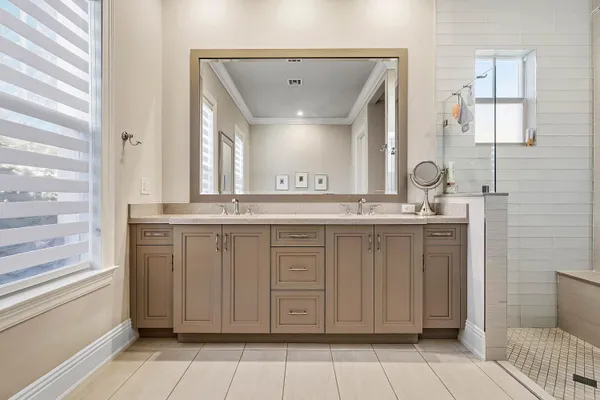 a bathroom with a granite countertop sink a mirror and a vanity
