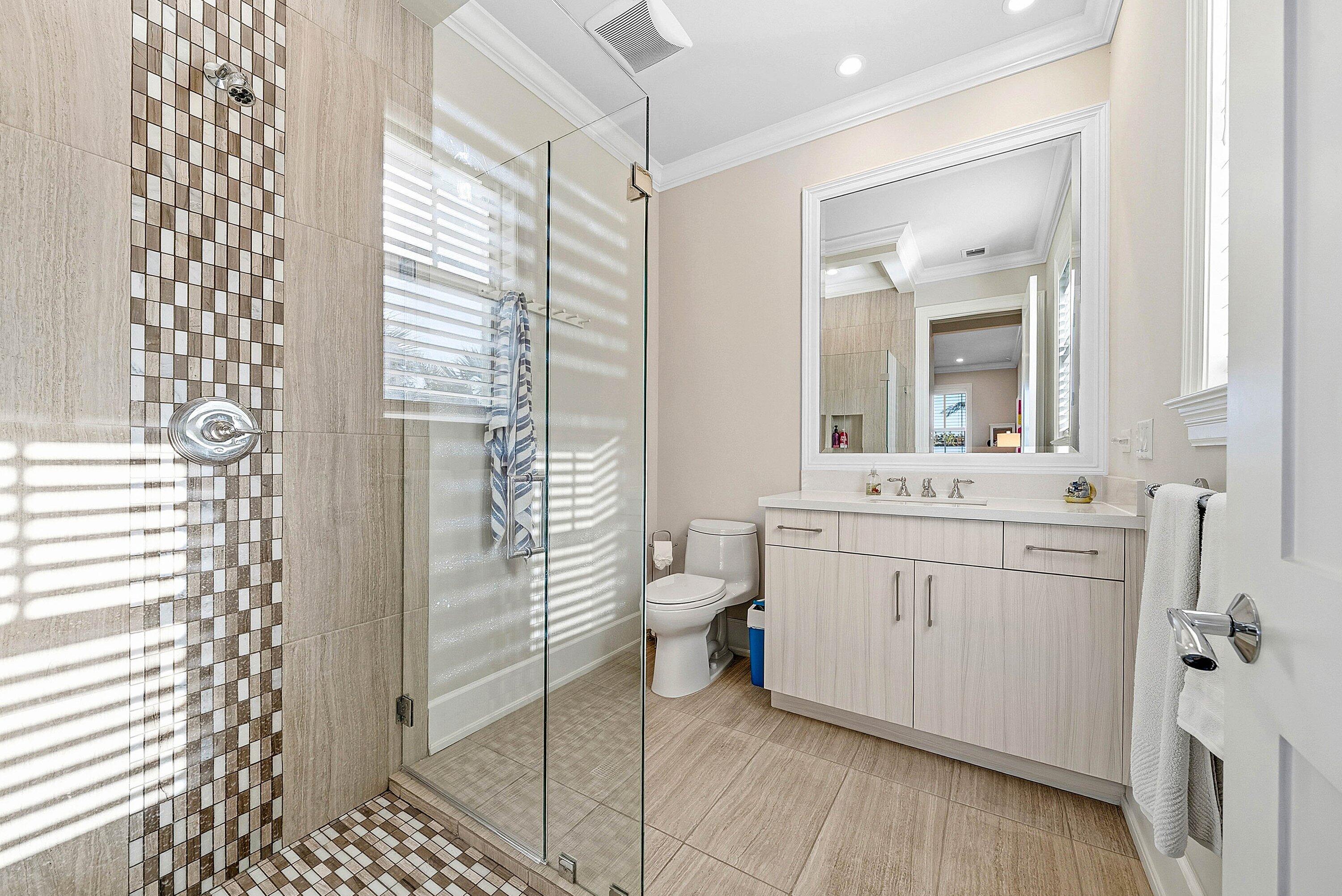 120 Grove Way Delray Beach, FL 33444 - Photo 28 of 43 a spacious bathroom with a shower a sink and a mirror