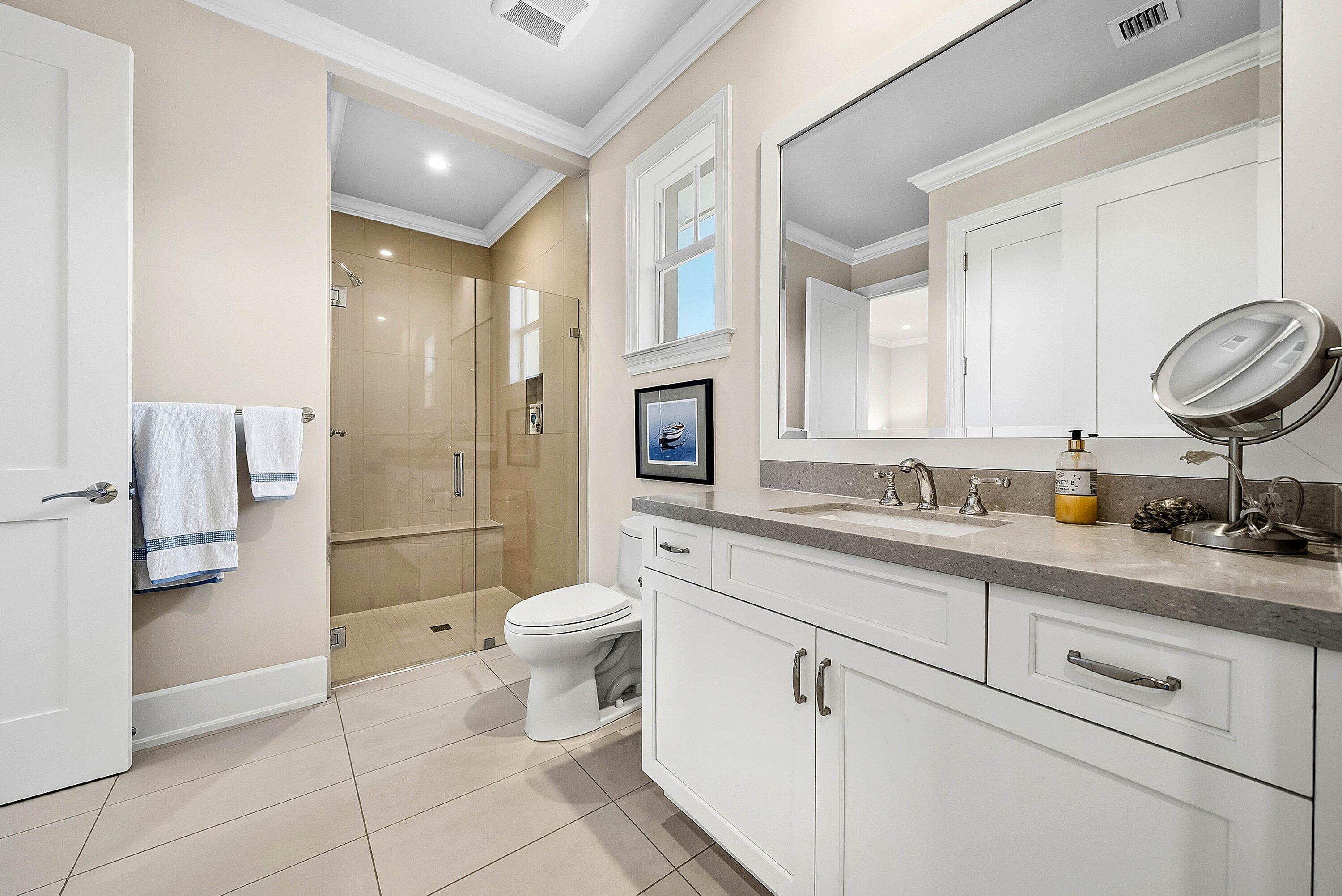 120 Grove Way Delray Beach, FL 33444 - Photo 30 of 43 a bathroom with a granite countertop sink a toilet and a mirror