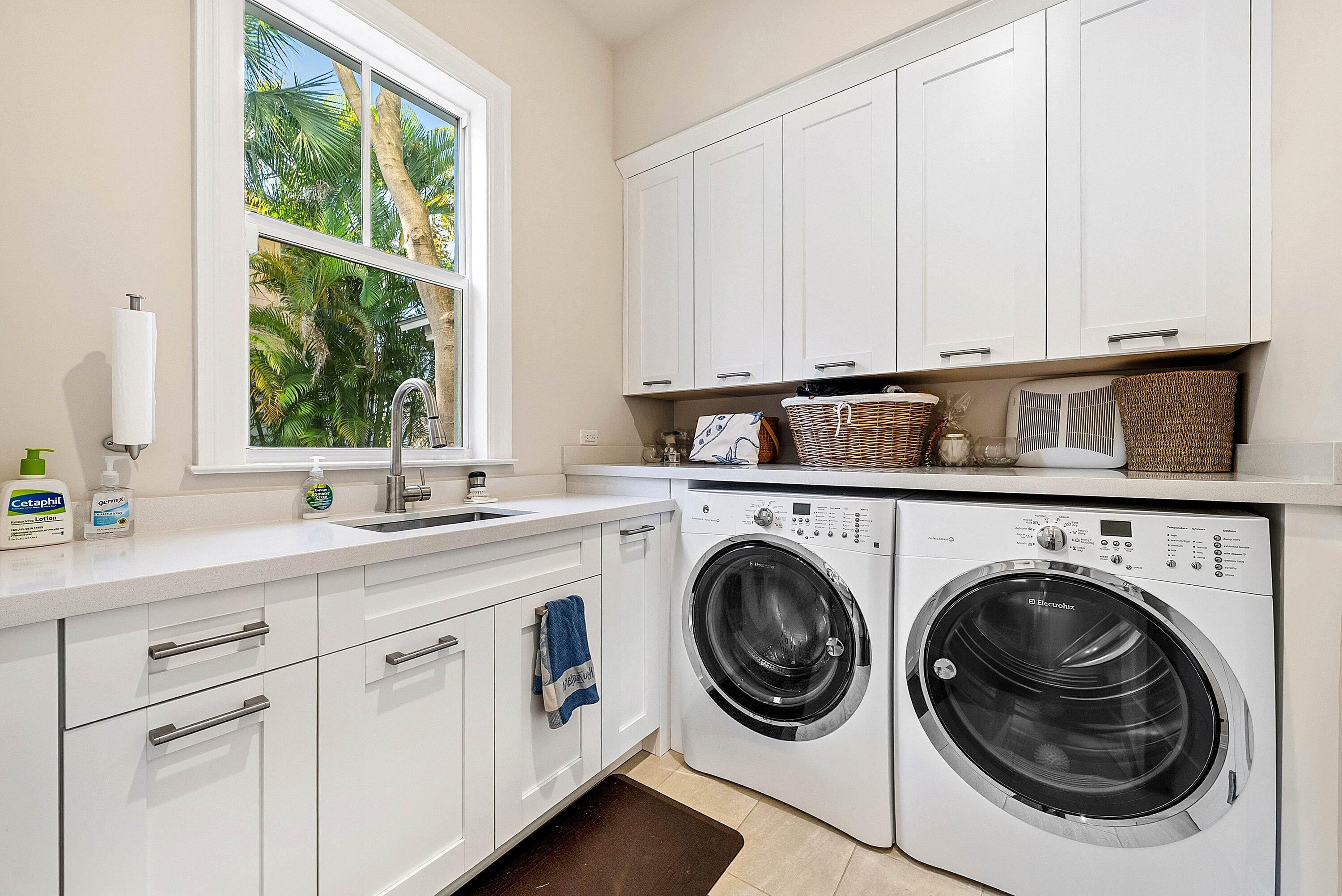 120 Grove Way Delray Beach, FL 33444 - Photo 34 of 43 a kitchen with a sink a washer and dryer next to a window