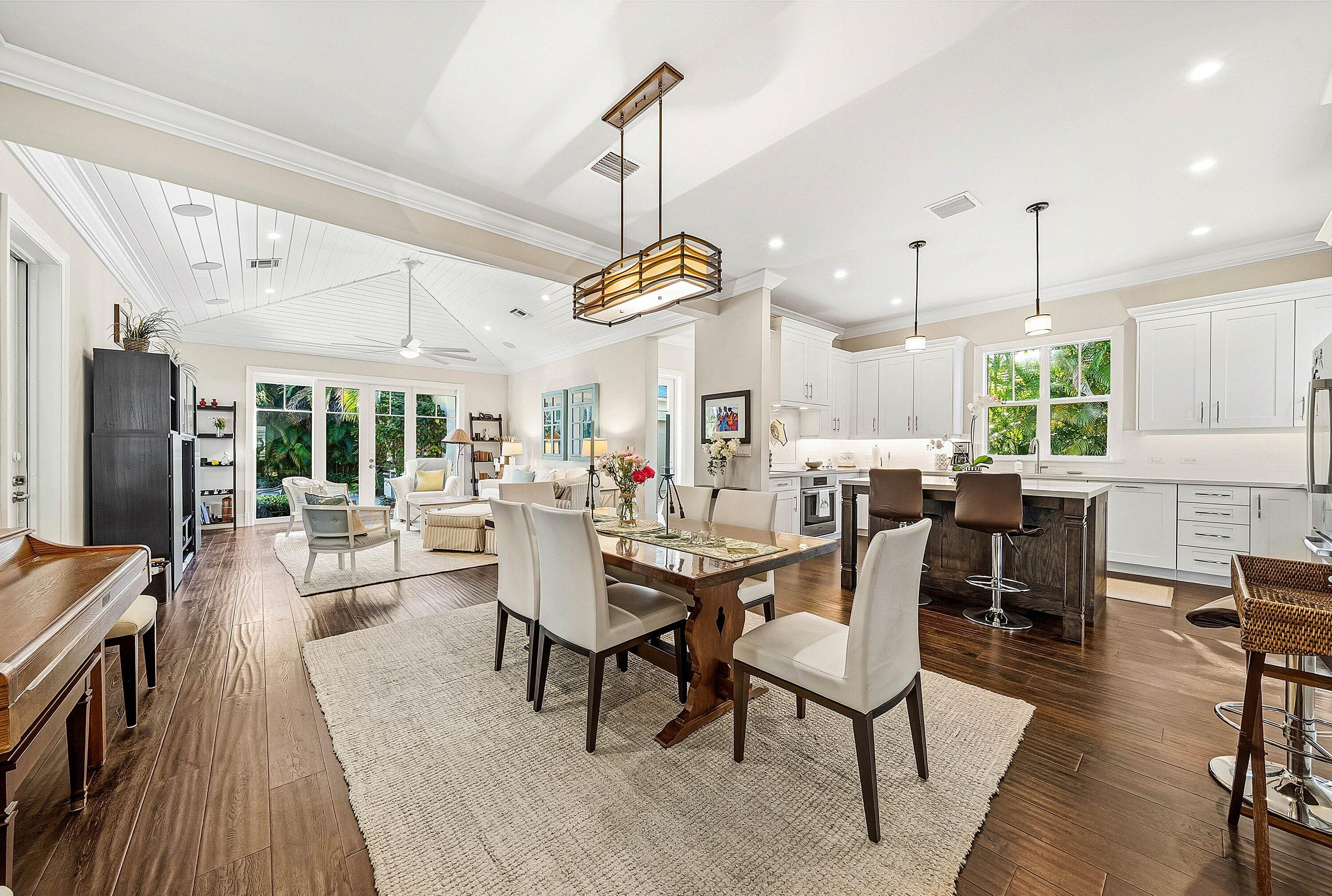 120 Grove Way Delray Beach, FL 33444 - Photo 10 of 43 a dining room with wooden floor a chandelier a wooden table and chairs