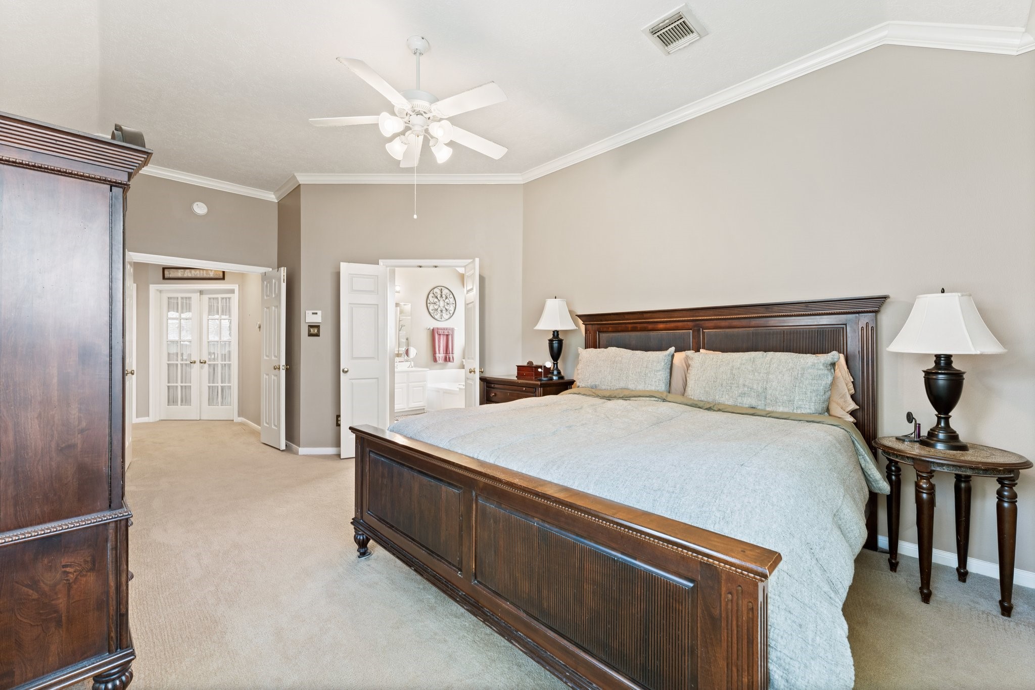 25447 China Springs Spring, TX 77373 - Photo 20 of 45 A peaceful double door primary bedroom designed for rest, with soft carpet and a layout that makes the space feel calm and private.