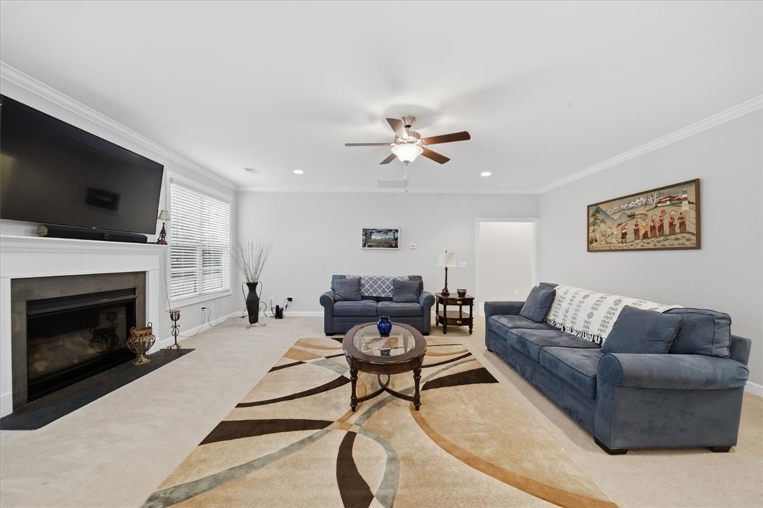 324 Crestgate Way Easley, SC 29642 - Photo 12 of 44 This inviting living room features a cozy fireplace, creating an ideal setting for relaxation.