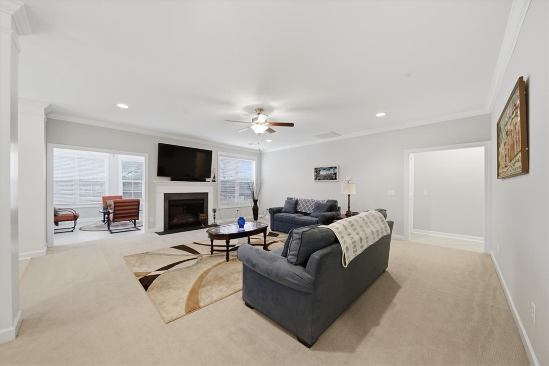 324 Crestgate Way Easley, SC 29642 - Photo 13 of 44 This living area features a warm fireplace and ample natural light, perfect for gatherings.