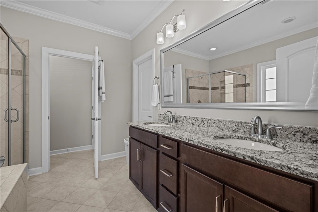 324 Crestgate Way Easley, SC 29642 - Photo 18 of 44 This spacious bathroom features a double vanity and a sleek shower, perfect for daily routines.