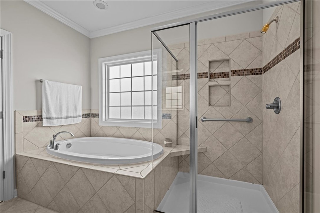324 Crestgate Way Easley, SC 29642 - Photo 19 of 44 Relax in this inviting bathroom featuring a deep soaking tub and a spacious walk-in shower.