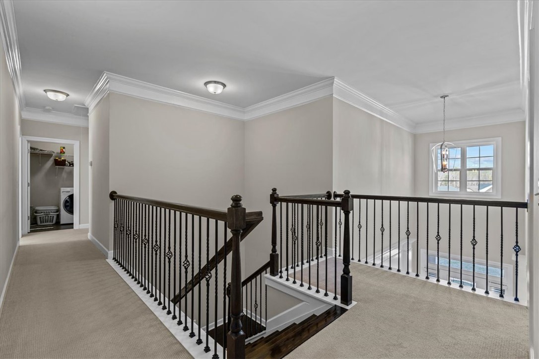 324 Crestgate Way Easley, SC 29642 - Photo 20 of 44 This spacious landing features elegant crown molding and a prominent window, offering abundant natural light.