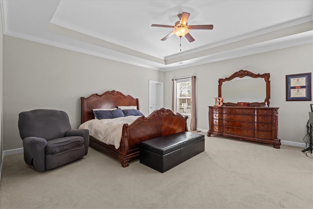 324 Crestgate Way Easley, SC 29642 - Photo 21 of 44 This spacious primary bedroom features a cozy tray ceiling, providing a serene retreat.