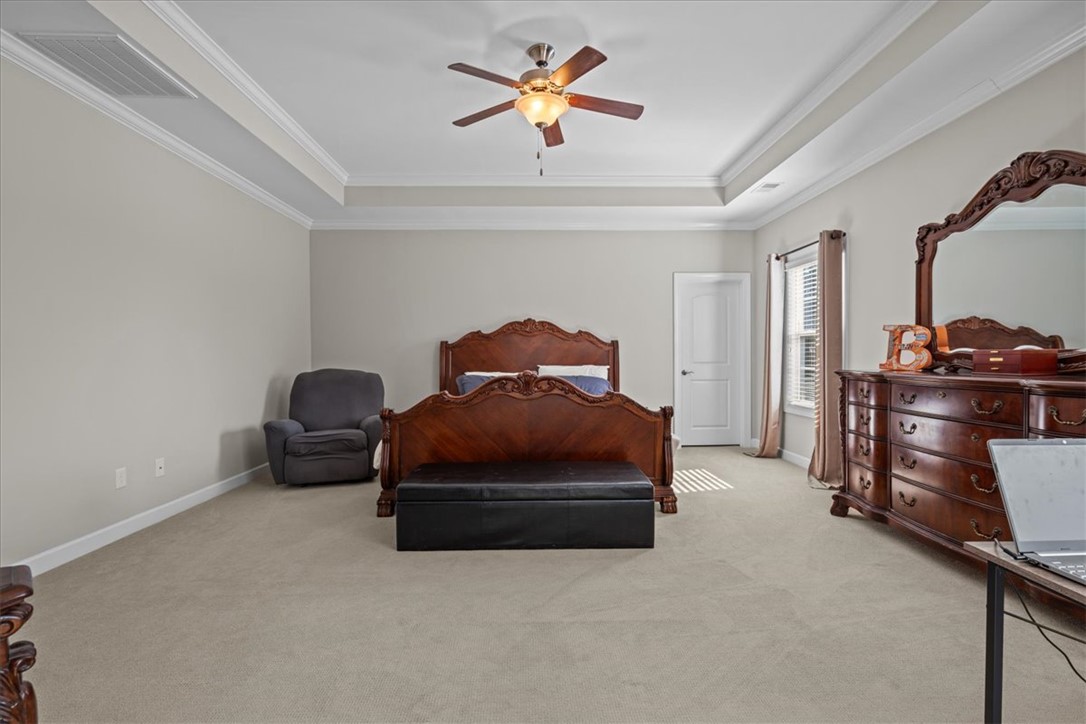 324 Crestgate Way Easley, SC 29642 - Photo 23 of 44 This spacious bedroom offers comfortable living with elegant ceiling details and soft carpeting.