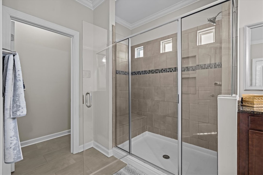 324 Crestgate Way Easley, SC 29642 - Photo 25 of 44 This primary bathroom features a spacious shower with sleek tile and a refreshing rainfall showerhead.
